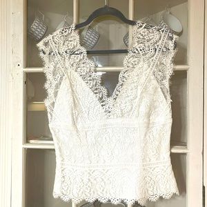Beautiful scalloped edge lace overlay tank with a deep v in the back.